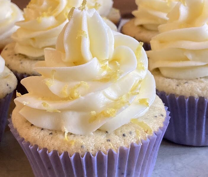 Cupcake with white frosting and yellow sprinkles